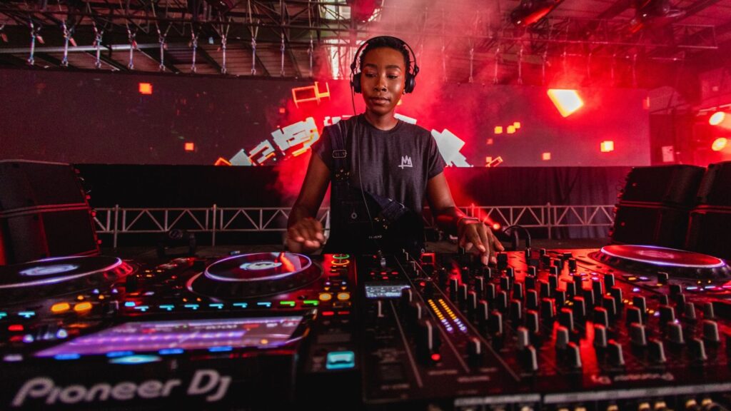 Shamiso in her element - behind the decks at Ultra South Africa, lit by the glow of stage lights and pure energy. There’s joy on her face and rhythm in her stance. as The whole world is dancing with her. A sacred moment, and she’s at the heart of it.